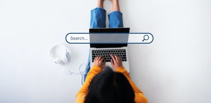 Woman using her laptop with a search box in the middle
