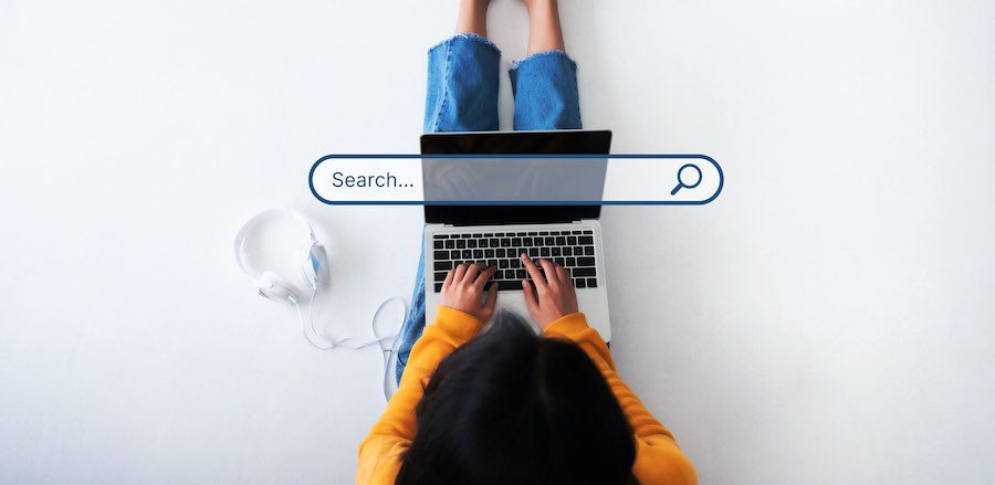Woman using her laptop with a search box in the middle